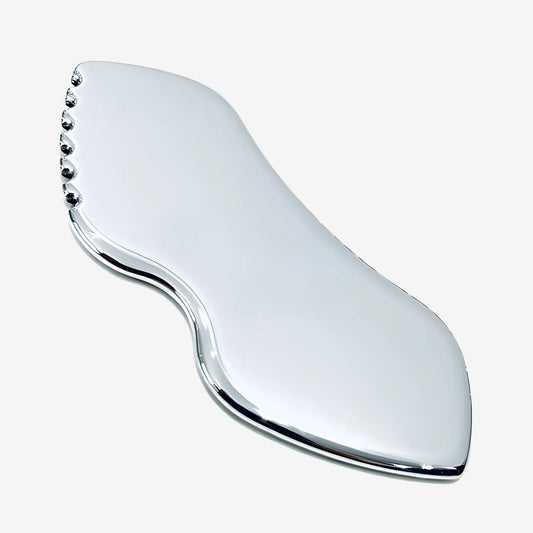 Silver, stainless steel gua sha face massager.